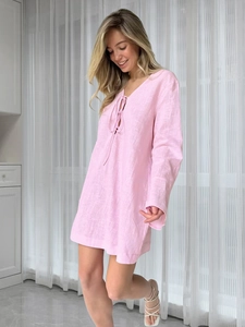 Detail of pink cotton nightdress featuring a lace-up V-neck and soft breathable fabric