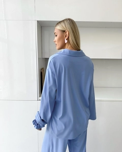 Rear view of a light blue long-sleeved chiffon pajama set for women in a kitchen setting