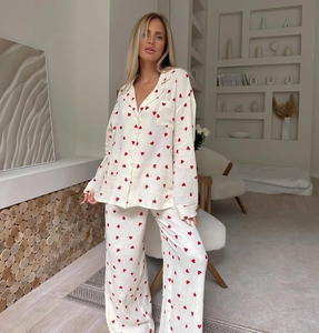 Close-up of heart print pajama fabric and breast pocket on long sleeve button-up top