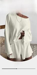 Close-up of white ribbed knit fabric texture on breathable long-sleeve loungewear set