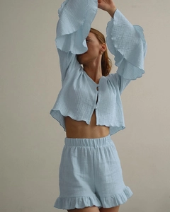 Detail of light blue cotton pajama set with ruffle hem and breathable crinkle texture