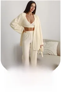 Detail of soft cream knit fabric texture on women's three-piece loungewear set
