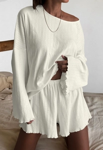 Detail of white long-sleeve loungewear set with vertical rib texture and ruffle edges