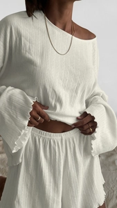 Detail of white two-piece loungewear set featuring bell sleeves and textured fabric