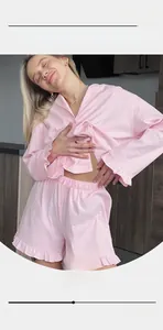 Detail view of pink long-sleeved pajamas set with ruffle hem and elastic waistband
