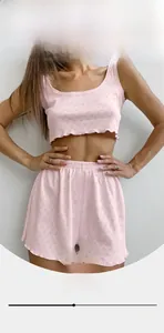 Detailed view of heart-shaped hollow knit pattern and wavy lettuce edge on pink vest set
