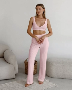 Detail of light pink knitted loungewear set with soft cable knit texture for women
