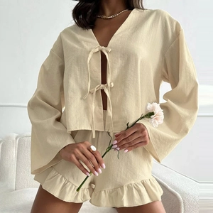 Chic beige two-piece lounge set with tie-front long sleeves and ruffled shorts