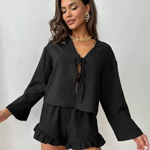 Women's black lounge set with tie-front long sleeve top and ruffle hem shorts
