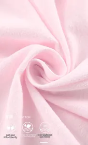 Close-up of soft pink 100% cotton fabric showing breathable texture and fine weave
