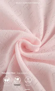 Detail of pink knitted polyester fabric featuring delicate heart cut-out patterns