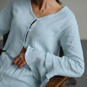 Women's light blue cotton pajamas set featuring ruffled sleeves and textured fabric