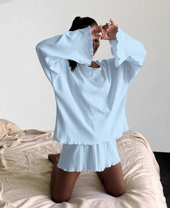 Detail of light blue loungewear set with textured rib knit fabric and wavy lettuce trim