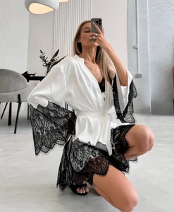Detail view of white satin robe featuring exquisite black eyelash lace trim on sleeves