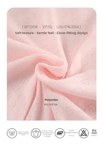 Close-up of soft pink knit fabric featuring a delicate hollow-out heart pattern design
