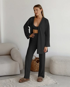 Detail view of black three-piece knitted loungewear set with fine ribbed texture fabric