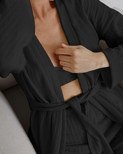 Detail of black knit loungewear set with diamond texture and elegant wrap robe