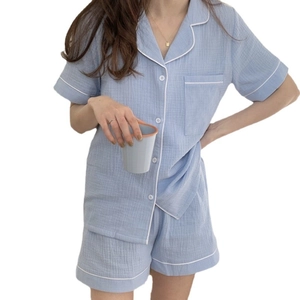 Women's light blue short sleeve gauze pajama set with white piping on white background
