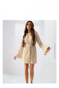 Detail of flared ruffled cuffs on a beige ribbed knit bathrobe for women
