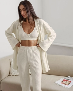 Detailed knit texture of a beige three-piece lounge set with cardigan and trousers