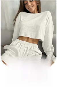 Detailed close-up of light grey knitted long sleeve crop top and matching shorts set