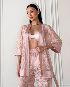 Detail of pink floral lace bathrobe and pants set with satin trim and sheer texture