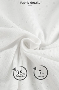 Detail of white pointelle knit fabric showing texture and 95% polyester 5% elastane blend