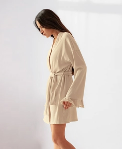 Detailed view of ribbed knit robe sleeve with elegant ruffled cuffs and belted waist