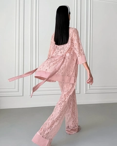 Rear view of elegant pink lace pajamas set featuring floral patterns and silky trim detail