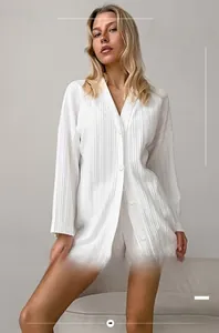 Close-up of white knit long-sleeved pajamas with delicate lace trim on the shorts