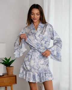 Detail of flared sleeves and ruffled hem on blue toile de jouy print satin robe