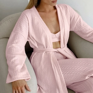 Cozy 3-piece pink knit lounge set featuring long cardigan, crop top, and wide-leg pants
