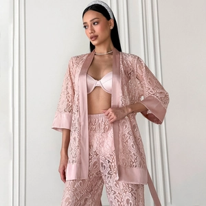 Pale pink three-piece lace pajama set with robe, satin top, and high-waisted pants