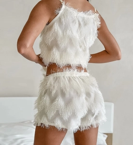Detail of white fringe tassel fabric on two-piece lounge set shown from the back view