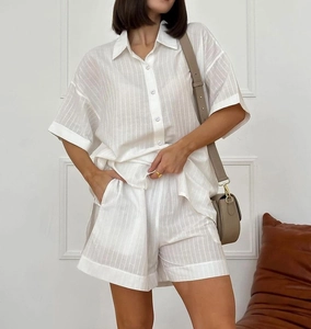 Detail of white striped summer pajamas set with short-sleeve shirt and high-waist shorts