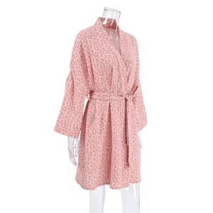 Detail of pink leopard print cotton bathrobe with tie belt and kimono collar on mannequin