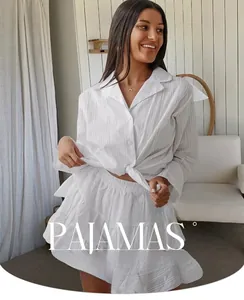 Detail of white cotton loungewear set featuring ribbed texture and ruffled shorts hem