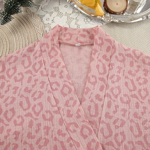 Close-up of pink leopard print bathrobe with V-neck collar and soft cotton texture