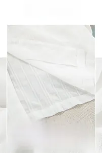 Close-up of white cotton pajamas showing fine stitching and vertical ribbed texture