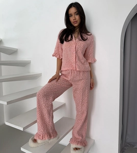 Detail of pink leopard print pajama set with ruffle trim on sleeves and pant cuffs