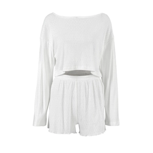Two-piece white knit loungewear set featuring long sleeve crop top and elastic waist shorts