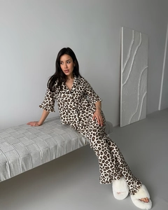 Close-up of leopard print pajamas set featuring ruffle sleeves and ruffled leg cuffs