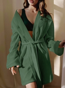 Detailed texture of dark green cotton robe fabric with drawstring waist detail
