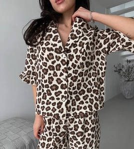 Detail of leopard print pajama top with buttons, ruffled sleeves and breathable texture