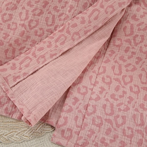Close-up of pink leopard print cotton bathrobe showing hem stitching and soft crepe texture