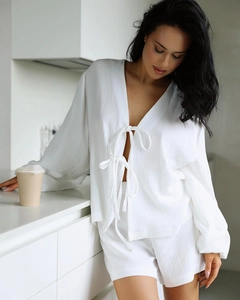 Detail of white crepe fabric texture on a long-sleeved tie-front pajamas set