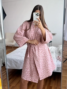 Detailed view of pink leopard print crinkle fabric texture on a cotton bathrobe