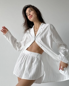 Detailed view of white cotton lounge set showing textured dobby fabric and vertical stripes