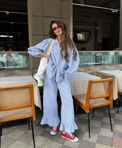 Detail of blue plaid loungewear set featuring ruffle hem pants and puff sleeves