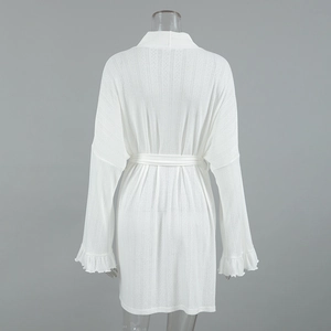 Detailed back view of white knit robe with ruffle sleeves and vertical textured stripes